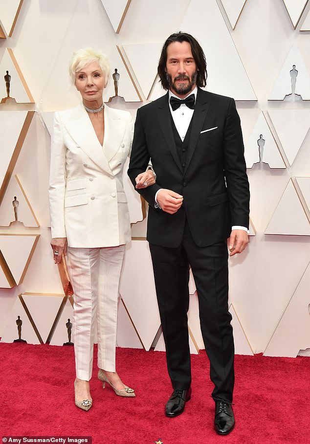 Suited up! Keanu - whose film Toy Story 4 won best animated feature - attended the Oscar ceremony with his mother, costume designer Patricia Taylor (L)