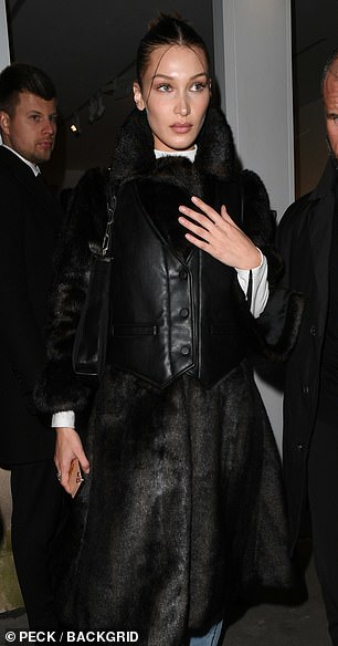 Fake fur? The model wore a calf length leather and fur look coat