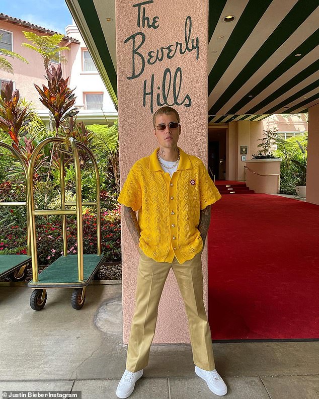 Mellow yellow: JB posed with his hands in his pockets in front of a pillar at the Beverly Hills Hotel entrance